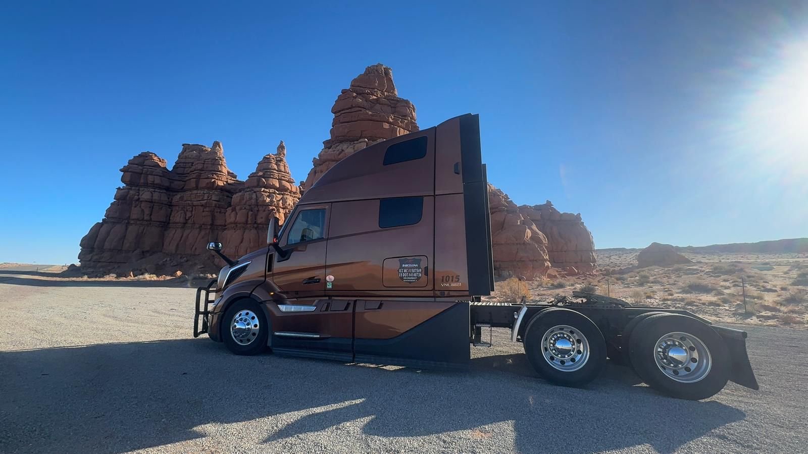 Barcelona Express tractor parked beside red rock hoodoos in Utah